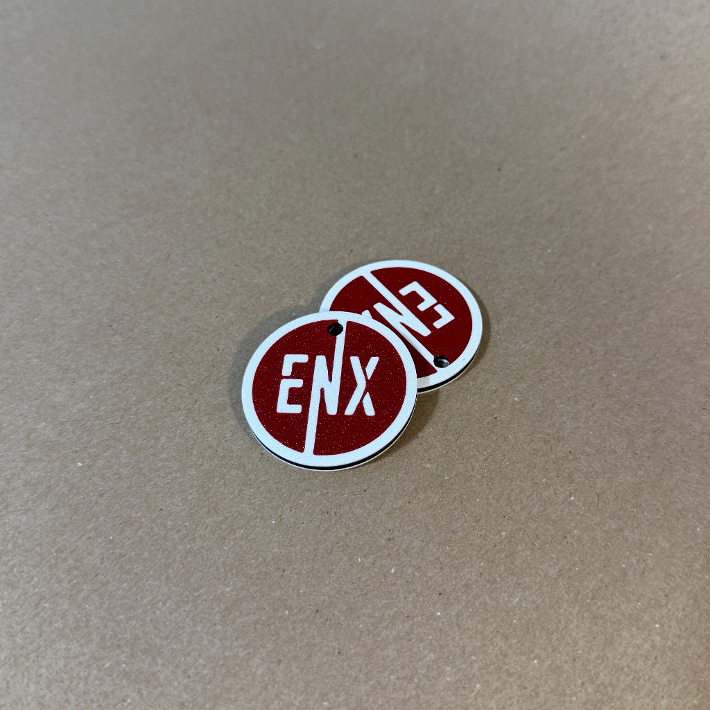 Pair of ENX Keychains with red and white branding